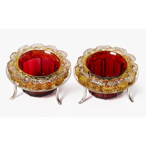 599 - A PAIR OF SILVER PLATED SALTS ON STANDS