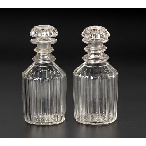 249 - A PAIR OF FLUTED GLASS DECANTERS