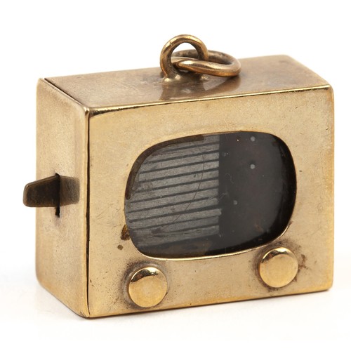 1 - A GOLD MUSIC BOX CHARM, CIRCA 1950