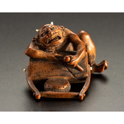 598 - A JAPANESE BOXWOOD NETSUKE OF AN ONI, MEIJI PERIOD, 1868 - 1912