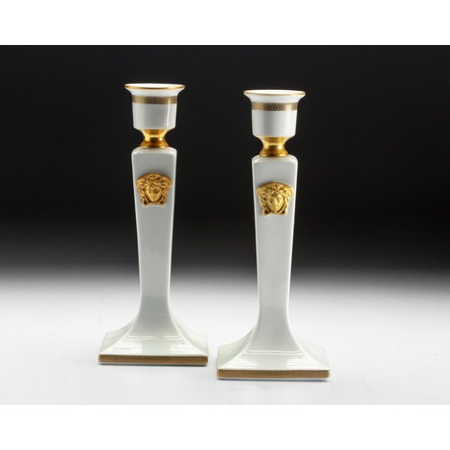 570 - A PAIR OF ROSENTHAL VERSACE WHITE AND GOLD 'GORGON' CANDLESTICKS