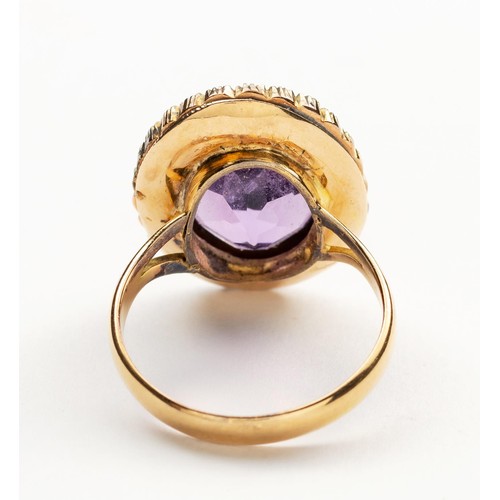 899 - AN AMETHYST AND SEED PEARL RING