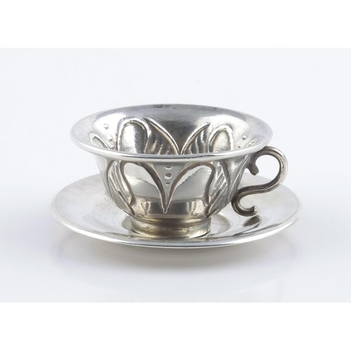 314 - A SILVER MINIATURE TEACUP AND SAUCER, MAKER AND DATE MARKS RUBBED