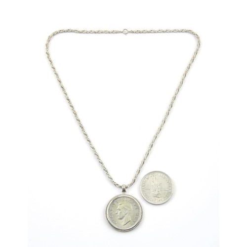 1703 - A SILVER COIN PENDANT AND SILVER COIN