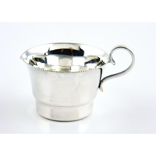 318 - A SILVER CREAM JUG, MAKER AND DATE MARKS RUBBED