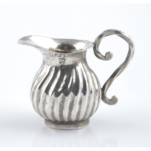 301 - A SILVER MINIATURE MILK JUG, MAKER AND DATE MARKS RUBBED