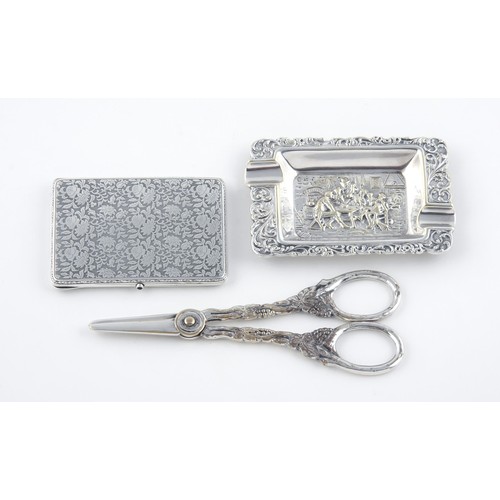 406 - A PAIR OF SILVER PLATE GRAPE SCISSORS, AN ASHTRAY AND A CARD HOLDER, VARIOUS MAKERS AND DATES