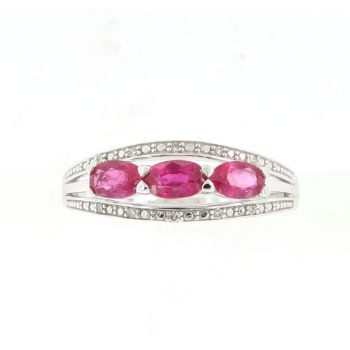 242 - A DIAMOND AND RUBY RING