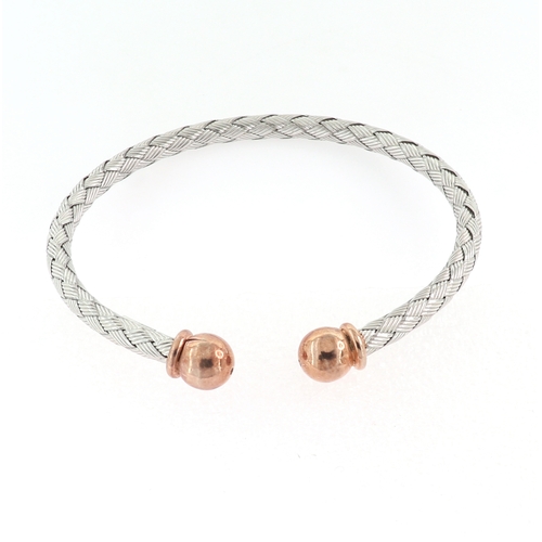 184 - A SILVER AND ROSE GOLD WIRE BANGLE