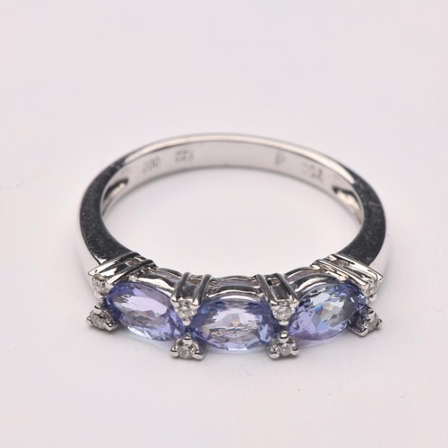 229 - A TANZANITE AND DIAMOND ETERNITY RING