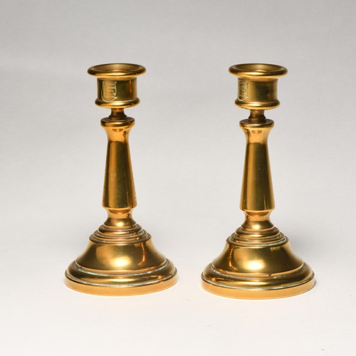 67 - A PAIR OF BRASS CANDLESTICKS