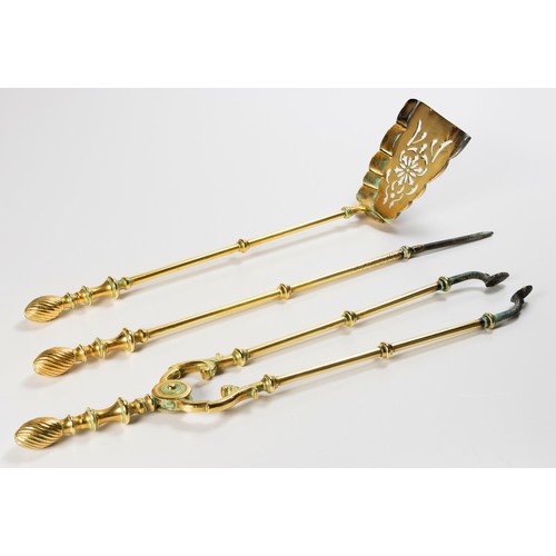 491 - A SET OF THREE EDWARDIAN BRASS FIRE IRONS