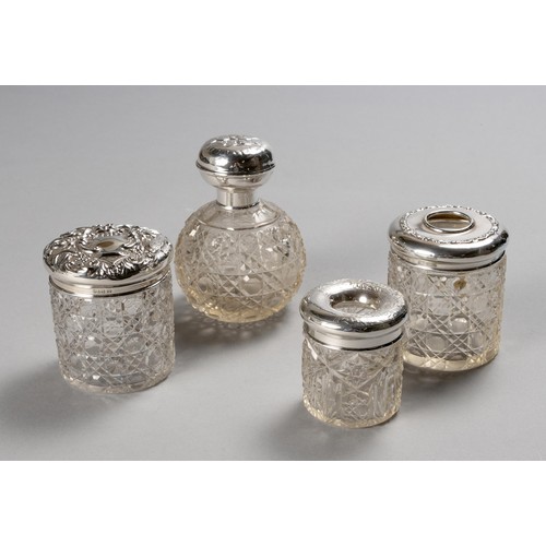 785 - THREE SILVER-MOUNTED AND GLASS DRESSING TABLE JARS AND ONE SILVER-MOUNTED AND GLASS SCENT BOTTLE