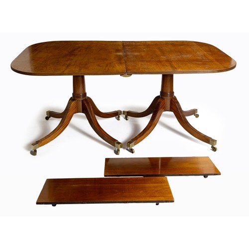 605 - A REGENCY MAHOGANY TWIN PEDESTAL EXTENDING DINING TABLE