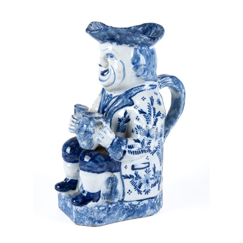 547 - A BLUE AND WHITE FAIENCE TOBY JUG, EARLY 19TH CENTURY