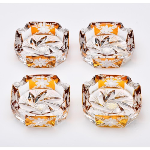 604 - A SET OF FOUR GLASS ASHTRAYS