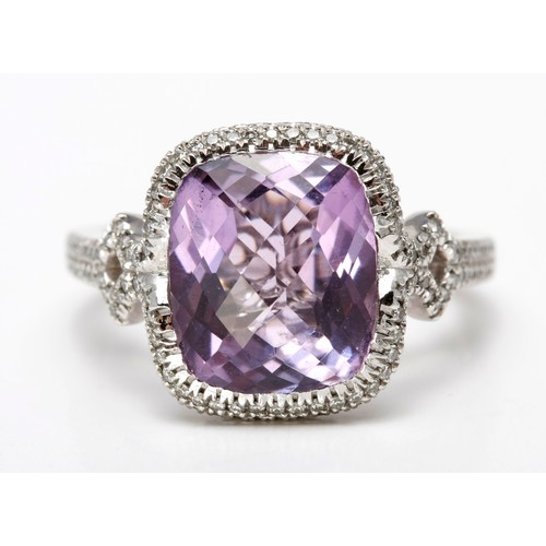 62 - AN AMETHYST AND DIAMOND DRESS RING