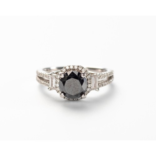 24 - A BLACK AND WHITE DIAMOND RING
