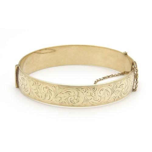 1466 - A 9CT GOLD PLATED METAL CORE BANGLE, LONDON, 20TH CENTURY