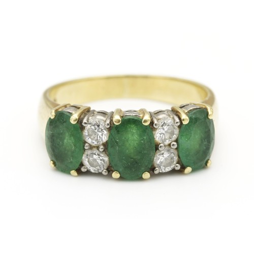 1445 - AN EMERALD AND DIAMOND DRESS RING