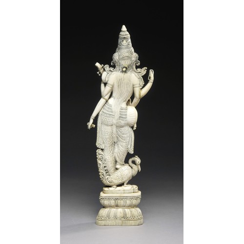 992 - AN INDIAN TUSK FIGURE OF A SARASWATI, 19TH CENTURY