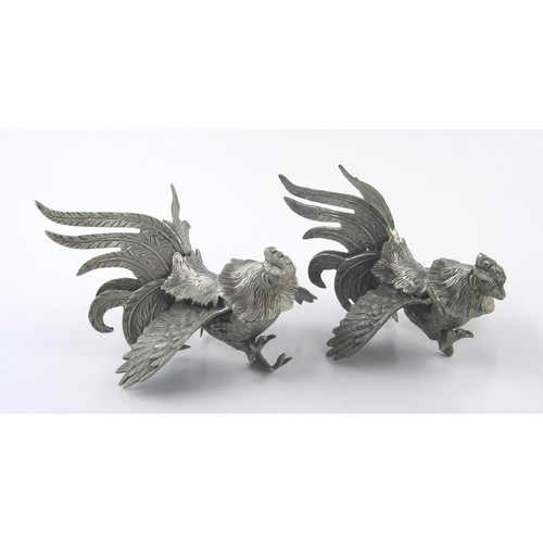 640 - A PAIR OF WHITE METAL FIGHTING COCKERELS