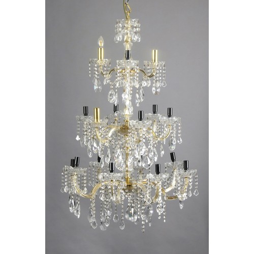 938 - A SIXTEEN LIGHT CUT-GLASS AND BRASS CHANDELIER