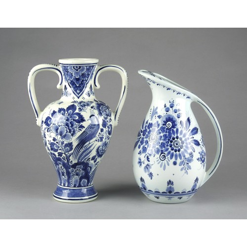 551 - A BLUE AND WHITE JUG AND URN IN THE STYLE OF DELFT