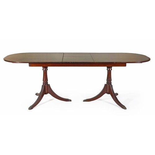 773 - A REGENCY STYLE EXTENDING MAHOGANY DINING TABLE