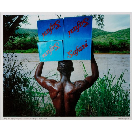 299 - Obie Oberholzer (South African 1947 - )STRONG MAN CARRYING BEER, GREAT RUAHA RIVER, NEAR MOROGORO, T... 