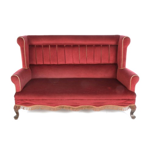 386 - AN UPHOLSTERED WINGBACK TWO-SEATER SETTEE