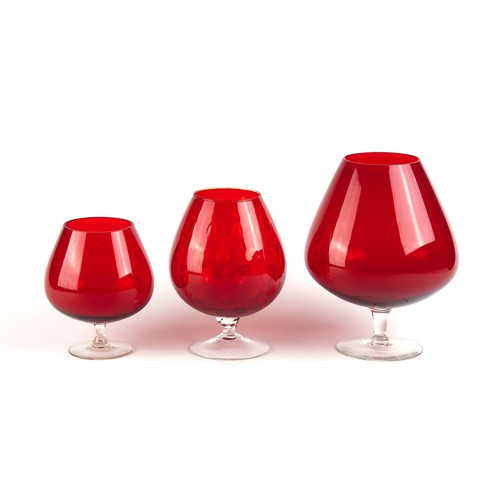 844 - A GROUP OF THREE RED GOBLET-STYLE VASES