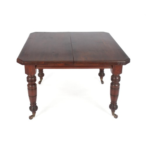 320 - A LATE VICTORIAN MAHOGANY EXTENDING DINING TABLE