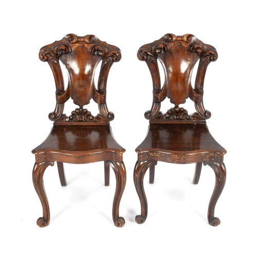 A PAIR OF VICTORIAN WALNUT HALL CHAIRS