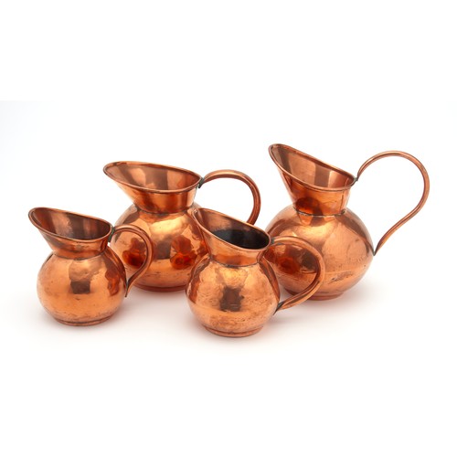 247 - A SET OF FOUR COPPER WATER JUGS