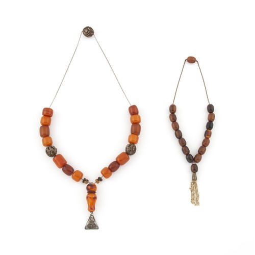 695 - A CHERRY AMBER NECKLACE AND A STRAND OF AMBER WORRY BEADS