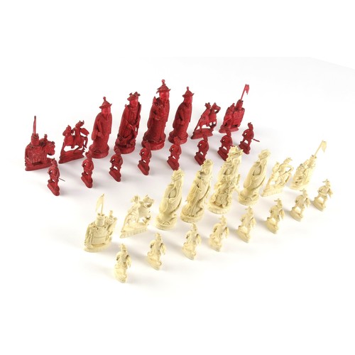 22 - A CARVED TUSK CHESS SET