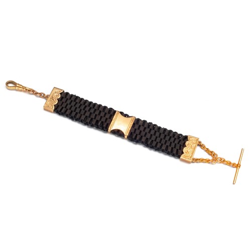 978 - A GOLD AND CORD FOB BRACELET