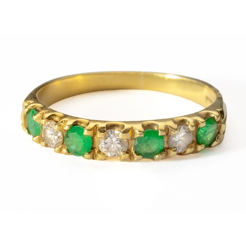 1017 - AN EMERALD AND DIAMOND ETERNITY RING