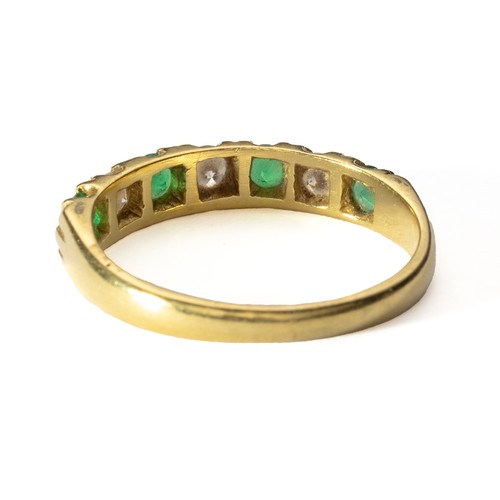 1017 - AN EMERALD AND DIAMOND ETERNITY RING