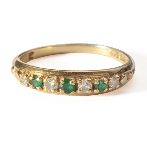 1016 - AN EMERALD AND DIAMOND ETERNITY RING