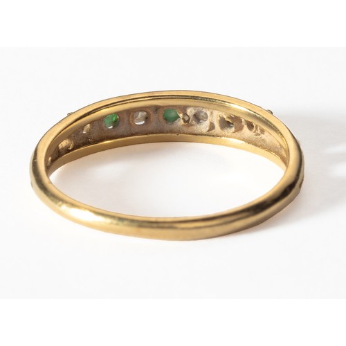 1016 - AN EMERALD AND DIAMOND ETERNITY RING