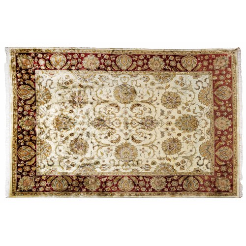 489 - A SILK AND WOOL INDIAN RUG 379 by 237cm