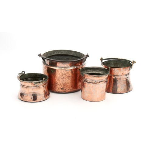 1192 - A COLLECTION OF FOUR COPPER POTS WITH SWING HANDLES