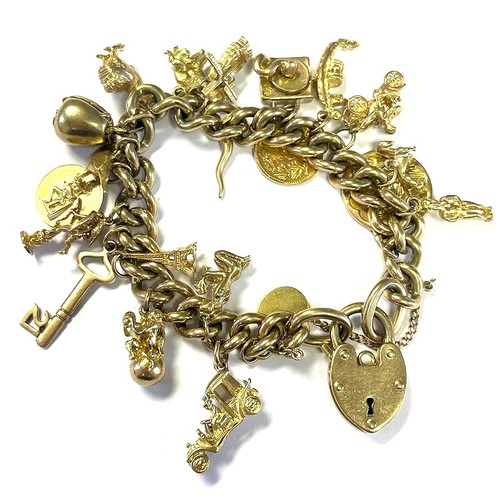 121 - A GOLD CHARM BRACELET