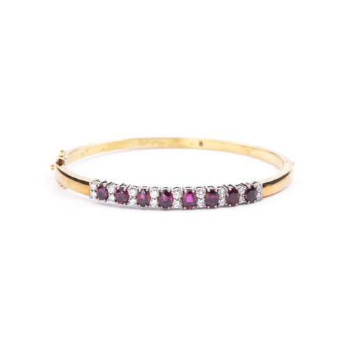 132 - A GOLD AND RUBY BANGLE, ITALY, 1990