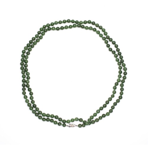 84 - A STRAND OF JADE-LIKE BEADS, OPERA LENGTH