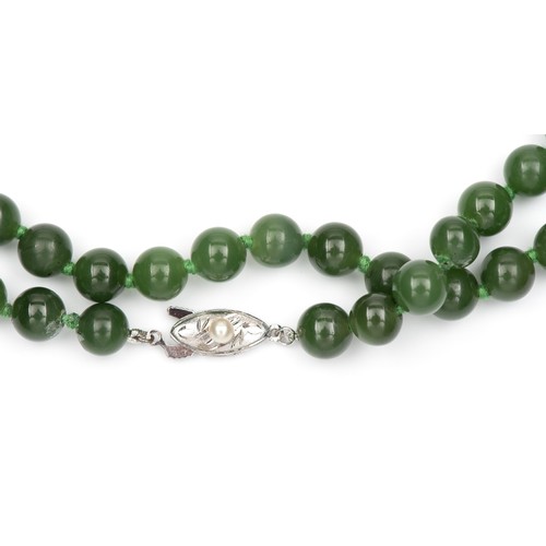 84 - A STRAND OF JADE-LIKE BEADS, OPERA LENGTH