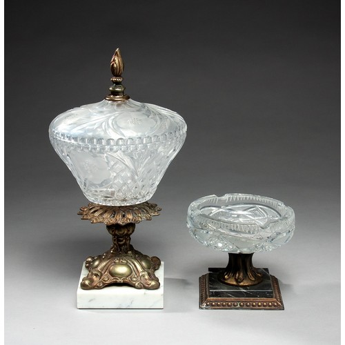 691 - A CUTGLASS JAR ON A GILT METAL STAND AND FINIAL AND A CUT GLASS ASHTRAY ON A GILT METAL STAND