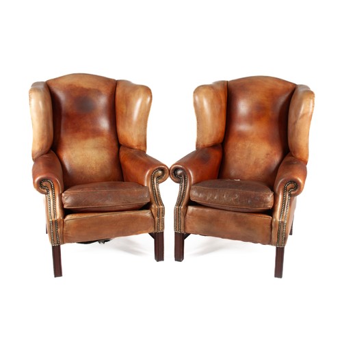 354 - A PAIR OF LEATHER UPHOLSTERED WINGBACK ARMCHAIRS